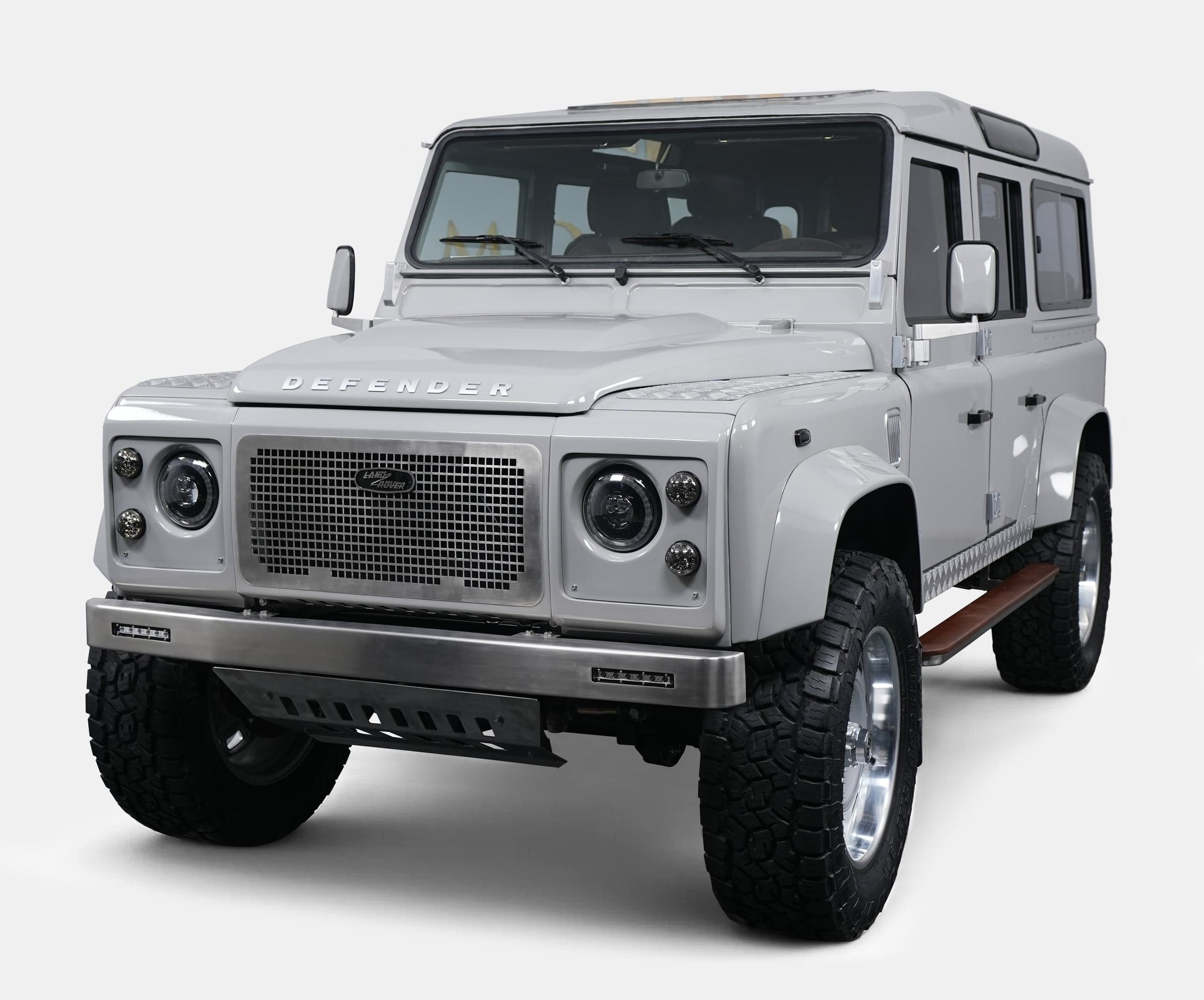 Luxury custom Land Rover Defender in white with aggressive stance and modern styling